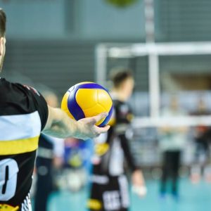 Volleyball player holds the ball before the service